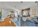 Spacious living room with hardwood floors and comfy seating at 216 Hickory Ave, Orange City, FL 32763