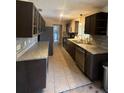 Galley kitchen with granite countertops and dark cabinetry at 218 W Magnolia Ave, Longwood, FL 32750