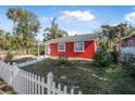 Red brick house with white picket fence and well-manicured lawn at 229 S Adams St, Daytona Beach, FL 32114