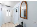 Bright condo entryway with tiled floor and mirror at 245 Terrace Hill Blvd # 1E, Debary, FL 32713