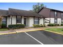 Condo building with parking and manicured lawn at 245 Terrace Hill Blvd # 1E, Debary, FL 32713