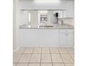 Bright kitchen with stainless steel sink, granite countertops, and white cabinetry at 245 Terrace Hill Blvd # 1E, Debary, FL 32713