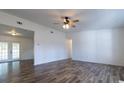 Bright living room featuring hardwood floors and a ceiling fan at 2709 Queen Palm Dr, Edgewater, FL 32141