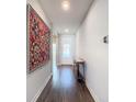 An entryway with dark hardwood floors, a large tapestry, and a console table at 281 Tuscany Chase Dr, Daytona Beach, FL 32117