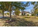 Landscaped front yard with mature trees and a well-maintained lawn at 3169 Connemara Dr, Ormond Beach, FL 32174