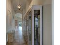 Bright hallway with tile flooring and built-in display cabinets at 3169 Connemara Dr, Ormond Beach, FL 32174