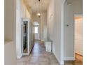 Spacious hallway featuring a glass-front cabinet and a light fixture at 3169 Connemara Dr, Ormond Beach, FL 32174