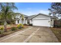 Two-car garage with a long driveway at 337 Orange Ave, Orange City, FL 32763