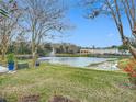 Serene pond view from backyard with fountain at 347 Castlewood Ln, New Smyrna Beach, FL 32168