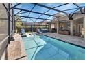 Inviting screened pool area with ample seating and outdoor grill, perfect for entertainment at 428 Hightower Dr, Debary, FL 32713
