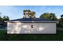 Rear view of a single story house with gray siding and two windows at 542 N Charles St, Daytona Beach, FL 32114
