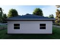 Rear view of a single story house with gray siding and two windows at 542 N Charles St, Daytona Beach, FL 32114