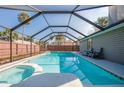A stunning screened-in pool and spa area with a covered enclosure and plenty of space for relaxation and entertaining at 709 Lone Oak Dr, Port Orange, FL 32127