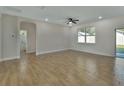 Open living room with wood-look floors and access to a bathroom at 731 E Cox St, Deland, FL 32724