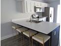 Updated kitchen with white cabinets and breakfast bar at 121 Reserve Cir # 209, Oviedo, FL 32765