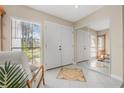 Bright foyer with tiled floor, mirrored wall, and view to backyard at 129 Oyster Catcher Ct, Daytona Beach, FL 32119