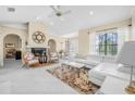 Spacious living room featuring white sectional sofa and a fireplace at 129 Oyster Catcher Ct, Daytona Beach, FL 32119