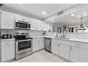 Modern kitchen with white cabinets, stainless steel appliances, and a breakfast bar at 1420 N Atlantic Ave # 1102, Daytona Beach, FL 32118