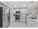 Modern kitchen with white cabinets, stainless steel appliances, and quartz countertops at 1420 N Atlantic Ave # 1102, Daytona Beach, FL 32118