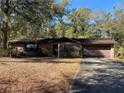 Brick ranch home with a carport and mature trees at 1525 S Hayden Rd, Deland, FL 32724
