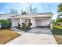 White single story home with covered carport and landscaping at 1612 Beatrice Dr, Orlando, FL 32810