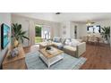 Bright living room with sectional sofa, coffee table, and hardwood floors at 1612 Beatrice Dr, Orlando, FL 32810