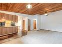 Open living room and kitchen with wood ceilings at 1668 Spring Garden Ct # 1668, Daytona Beach, FL 32117