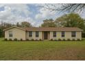Charming single-story home featuring a well-maintained lawn and classic architectural details at 1870 S Lehigh Dr, Deltona, FL 32738