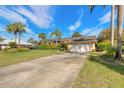 Lovely home with an expansive driveway, a two-car garage, and well-kept landscaping at 1930 Seclusion Dr, Port Orange, FL 32128