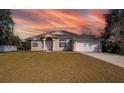 Single-story house with a landscaped lawn, driveway, and attached garage at 2370 Alton Rd, Deltona, FL 32738