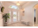 Bright and airy foyer with white shutters and a bench at 238 Venetian Palms Blvd, New Smyrna Beach, FL 32168