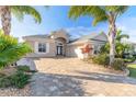 House exterior featuring a paver driveway at 238 Venetian Palms Blvd, New Smyrna Beach, FL 32168