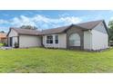 House exterior showcasing brick and vinyl siding with a well-maintained lawn at 2625 Sweet Springs St, Deltona, FL 32738
