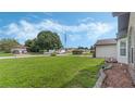 Landscaped front yard with a large tree and a view of the neighborhood at 2625 Sweet Springs St, Deltona, FL 32738