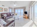 Spacious living room with ocean view and comfortable leather furniture at 2967 S Atlantic Ave # 1706, Daytona Beach, FL 32118