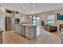 Island kitchen with granite countertops, stainless steel appliances, and view to backyard at 3009 Lake Tahoe St, Deland, FL 32724