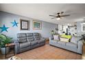 Comfortable living room featuring tile floors, neutral paint, and plush seating at 30215 Tavares Ridge Blvd # 11, Tavares, FL 32778