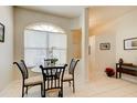 Small breakfast nook with glass table and chairs near the kitchen at 3162 Kailani Ct, Ormond Beach, FL 32174