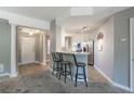 Open kitchen with island, stainless steel appliances, and grey walls at 424 Luna Bella Ln # 332, New Smyrna Beach, FL 32168