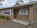 Inviting front porch with a green door at 432 Sauls St, Ormond Beach, FL 32174