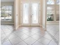 Elegant foyer with double doors featuring decorative glass and tile flooring at 43747 Choctaw St, Deland, FL 32720