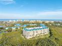 Breathtaking aerial view of the condo complex, showcasing the lush surroundings, ocean views, and stunning architecture at 4672 Riverwalk Village # 8406, Ponce Inlet, FL 32127