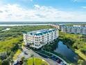 Aerial view of the condo community with beautiful landscaping, waterfront views, and convenient parking at 4672 Riverwalk Village # 8406, Ponce Inlet, FL 32127