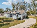 Beautiful exterior view with a long driveway, lush lawn, and attached garage at 475 W Main St, Lake Helen, FL 32744
