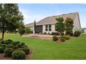 Landscaped backyard with patio and screened porch at 5589 Nw 40Th Loop, Ocala, FL 34482