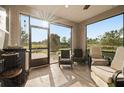 Relaxing screened porch with wicker furniture at 5589 Nw 40Th Loop, Ocala, FL 34482