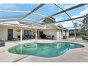 Relaxing kidney-shaped pool with a screened enclosure and patio at 675 Winterberry Trl, Deland, FL 32724