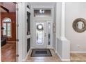 Bright and spacious entryway with tile floors and a decorative mirror at 676 Newhall Ln, Debary, FL 32713