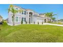 Two-story house with gray exterior, stone accents, and a three-car garage at 6832 Forkmead Ln, Port Orange, FL 32128