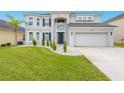 Two-story house with gray exterior, stone accents, and a three-car garage at 6832 Forkmead Ln, Port Orange, FL 32128